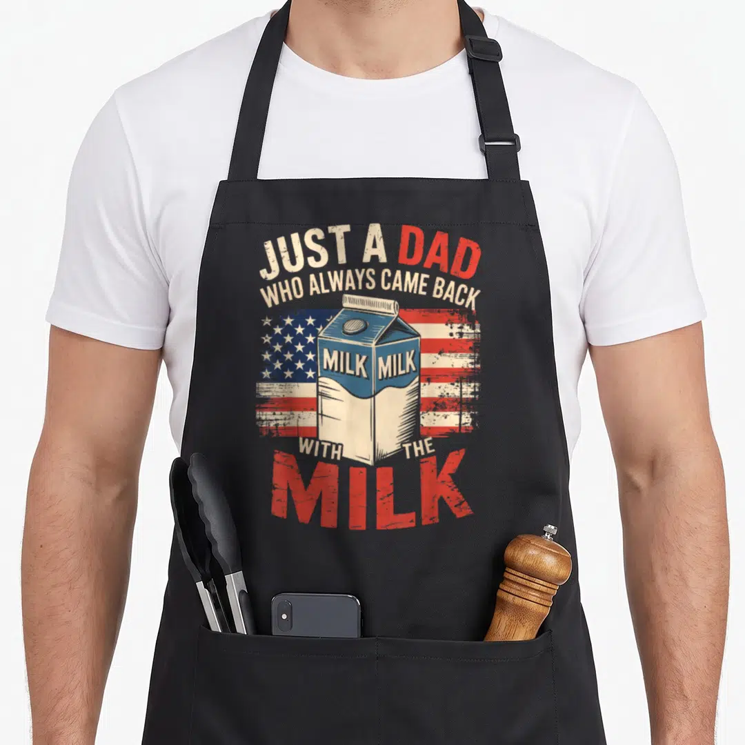 Father milk aprons - Distressed milk carton on USA flag with Just a Dad Who Always Came Back With The Milk text — shown on a black cotton canvas apron against a white background