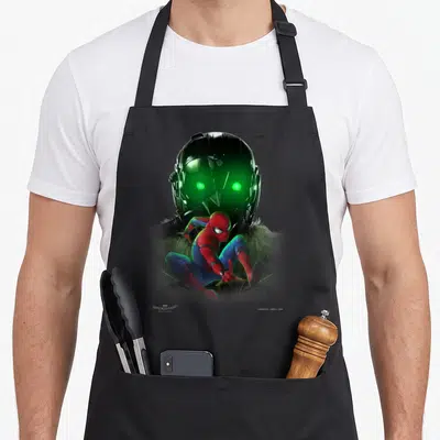 Homecoming vulture apron - Spider-Man crouching in red and blue before a black helmet with glowing green eyes — shown on a black cotton canvas apron against a white background
