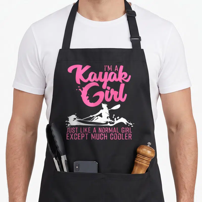 Paddling kayak apron - Pink text I'm A Kayak Girl above white female paddler silhouette and bottom slogan — shown on a black cotton canvas apron against a white background