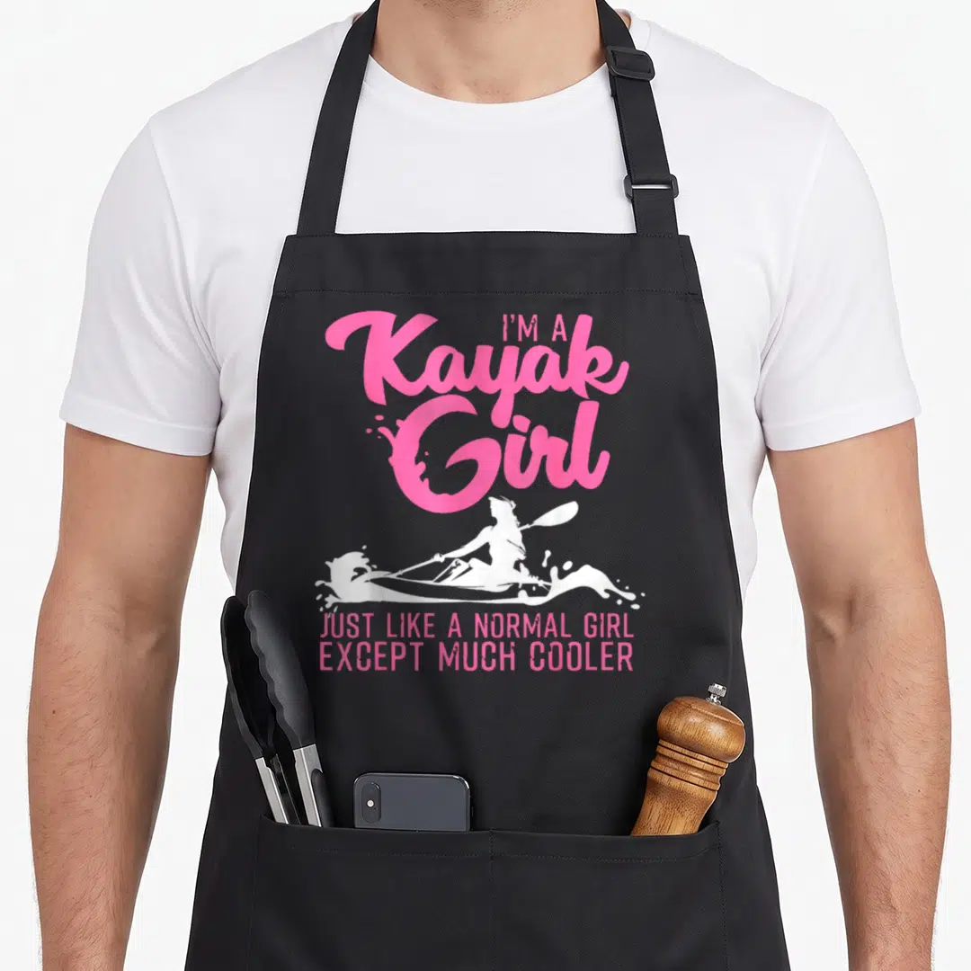 Paddling kayak apron - Pink text I'm A Kayak Girl above white female paddler silhouette and bottom slogan — shown on a black cotton canvas apron against a white background