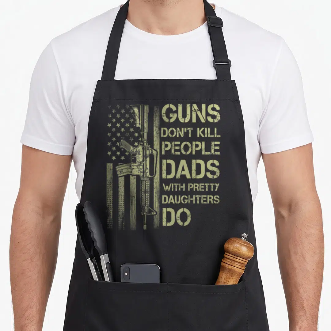 Gun pretty apron - Olive green rifle superimposed over vertical flag with stacked sarcastic text about dads — shown on a black cotton canvas apron against a white background