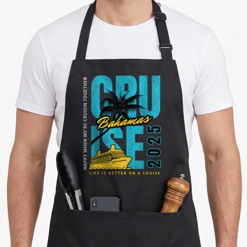 Cruise bahamas apron - Retro cruise ship and palm tree with 2025 text in blue and yellow — shown on a black cotton canvas apron against a white background