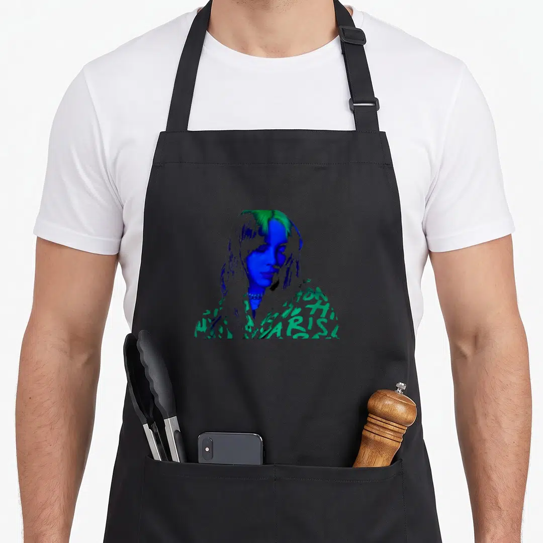 Billie novelty apron - Color-inverted photo portrait of a woman in blue green and white — shown on a black cotton canvas apron against a white background