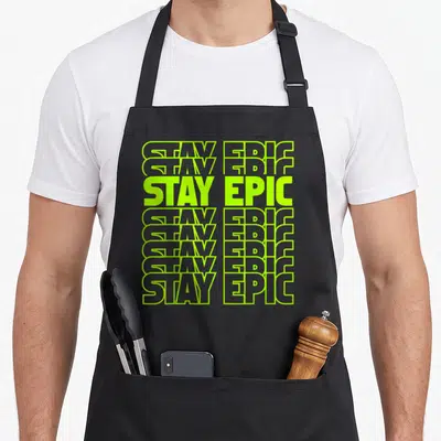 Stay lime green apron - STAY EPIC repeated eight times in lime green outlined and solid typography stack — shown on a black cotton canvas apron against a white background