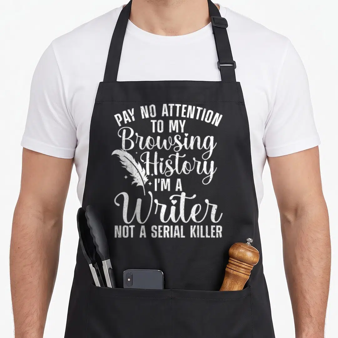 Author journalist apron - White stacked text reading Pay No Attention To My Browsing History I Am A Writer Not A Serial — shown on a black cotton canvas apron against a white background