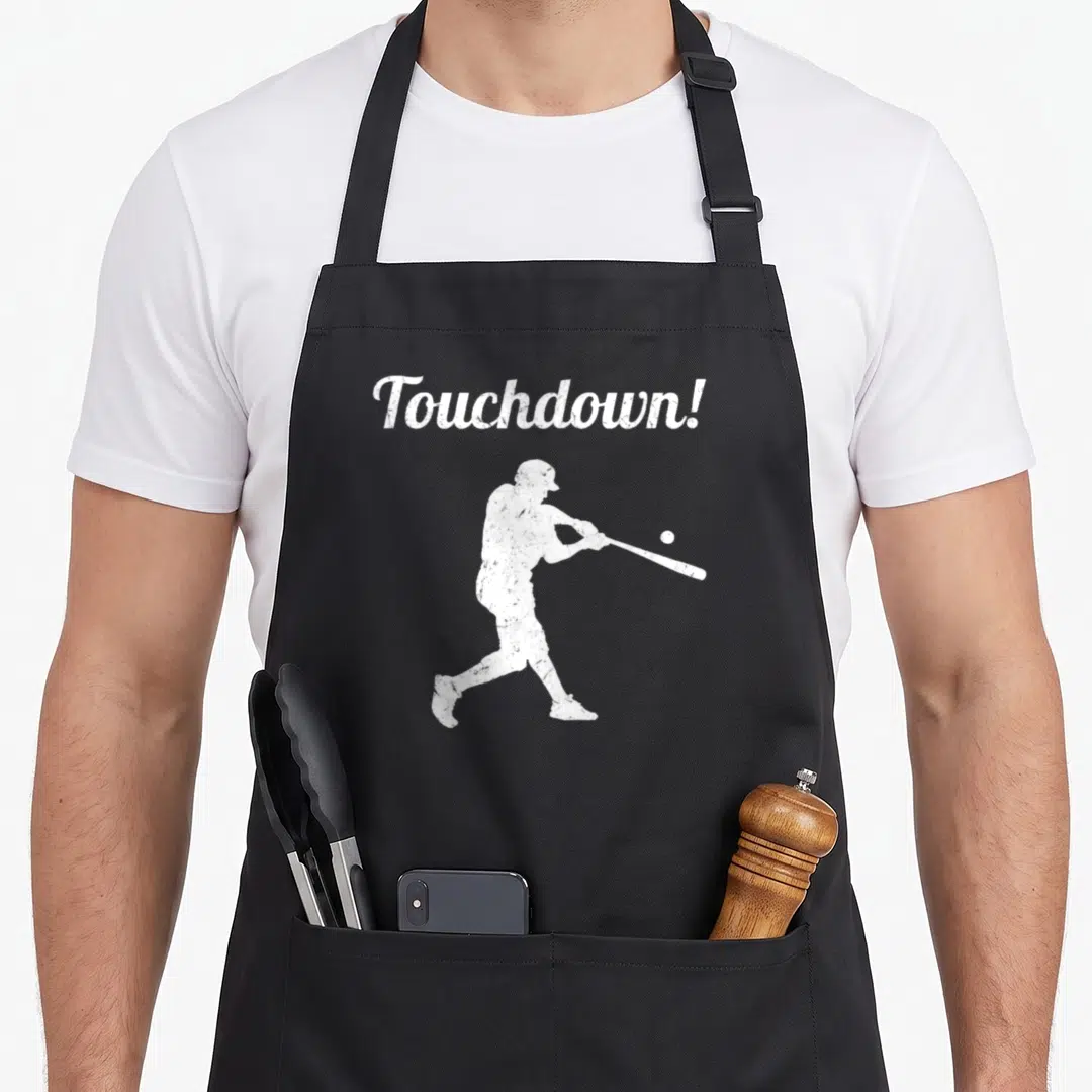 Touchdown baseball apron - White distressed silhouette of a batter swinging a bat under the word Touchdown! — shown on a black cotton canvas apron against a white background
