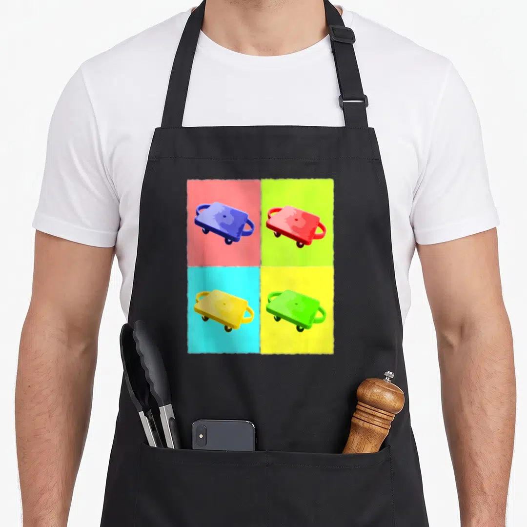 Physical scooter apron - Four dollies in blue red yellow green pink and cyan arranged in a 2x2 cartoon grid — shown on a black cotton canvas apron against a white background