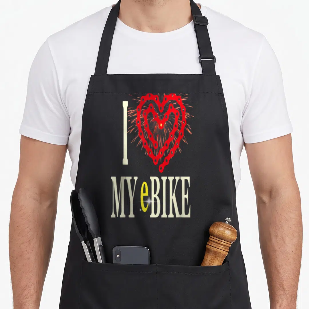 Ebike bike apron - I MY eBIKE text with red chain heart and yellow e letter — shown on a black cotton canvas apron against a white background