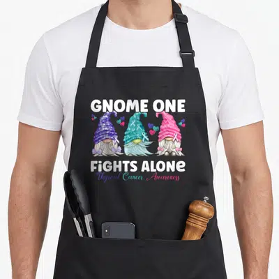 Gnome thyroid apron - Three cartoon gnomes in purple teal pink with ribbons and hearts — shown on a black cotton canvas apron against a white background