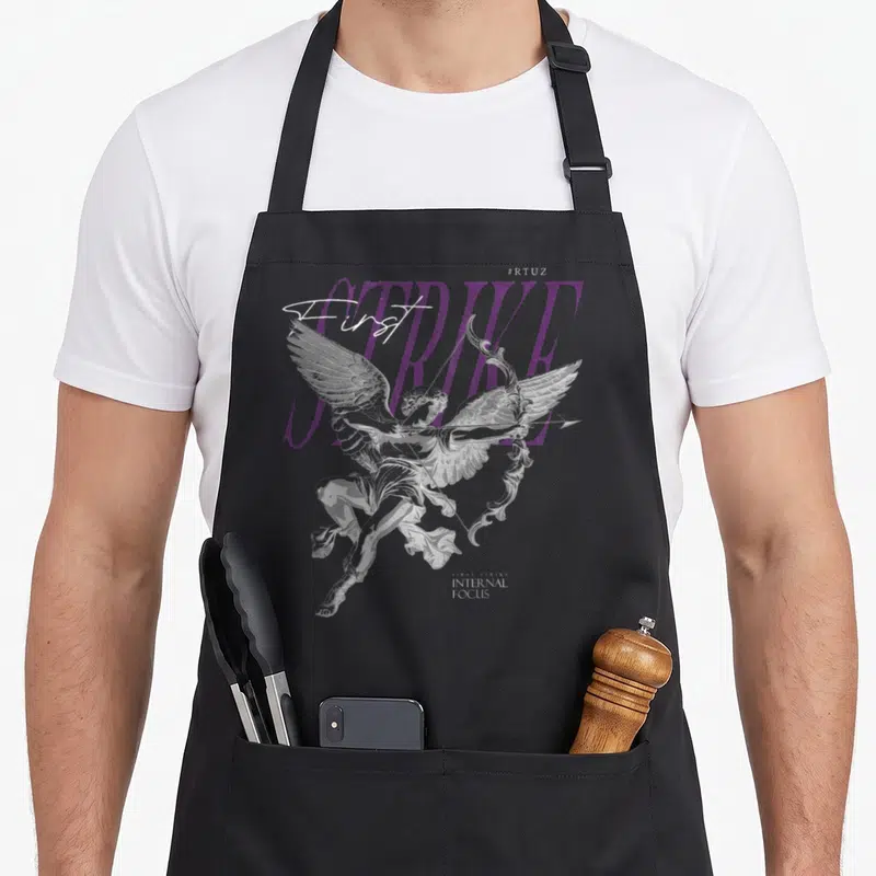 Y2k angels in aprons - Purple STRIKE text with white script First and grey Cupid statue on black bib — shown on a black cotton canvas apron against a white background