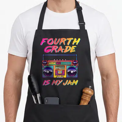 90s teacher apron - Retro boombox with pink yellow blue purple text reading Fourth Grade Is My Jam — shown on a black cotton canvas apron against a white background