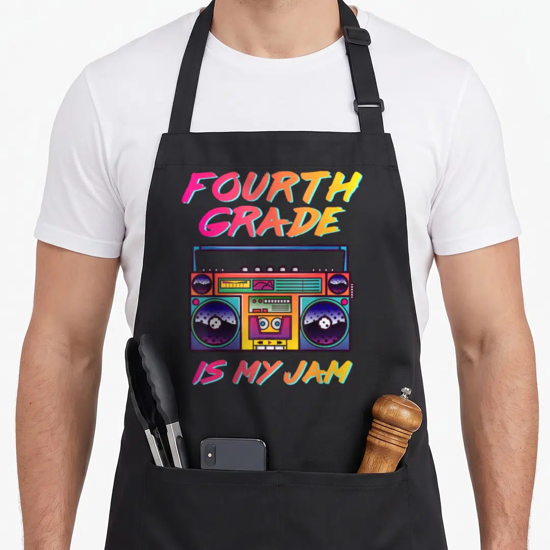 90s teacher apron - Retro boombox with pink yellow blue purple text reading Fourth Grade Is My Jam — shown on a black cotton canvas apron against a white background