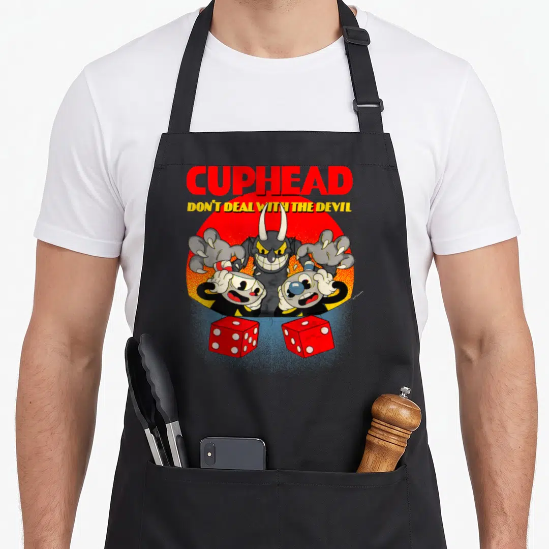 Cuphead video game apron - Devil horns and two red dice below Cuphead text warning — shown on a black cotton canvas apron against a white background