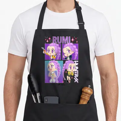 Rumi trend apron - Anime girl in 2x2 grid with RUMI text and vertical HUNTRX logo in purple and pink — shown on a black cotton canvas apron against a white background