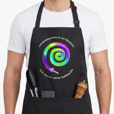 Consciousness meme apron - Rainbow fuzzy worm in spiral with white text consciousness is an illusion it's worm time — shown on a black cotton canvas apron against a white background