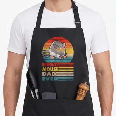 Outfit mouse dad apron - Grey mouse in sunglasses over retro striped sun with BEST MOUSE DAD EVER text — shown on a black cotton canvas apron against a white background