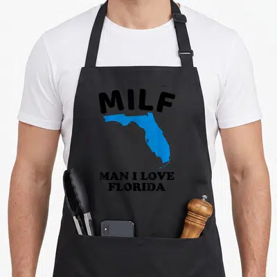 Milf miami florida apron - Black text MILF above blue Florida map silhouette with Man I Love Florida below — shown on a black cotton canvas apron against a white background