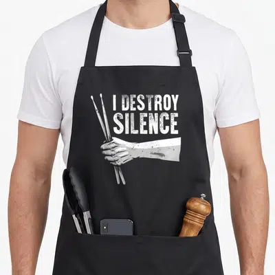 Drumming hilarious animals drummers apron - I destroy silence text above a white hand holding two drumsticks — shown on a black cotton canvas apron against a white background