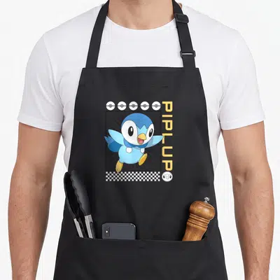 Piplup classical lover apron - Blue Piplup in black frame with vertical yellow text, white pokeballs, and checkerboard — shown on a black cotton canvas apron against a white background