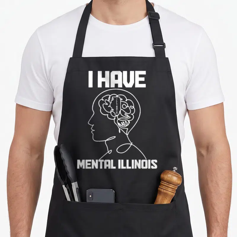 Mental pride apron - White line art head profile with brain containing Illinois state shape and text I Have Mental — shown on a black cotton canvas apron against a white background