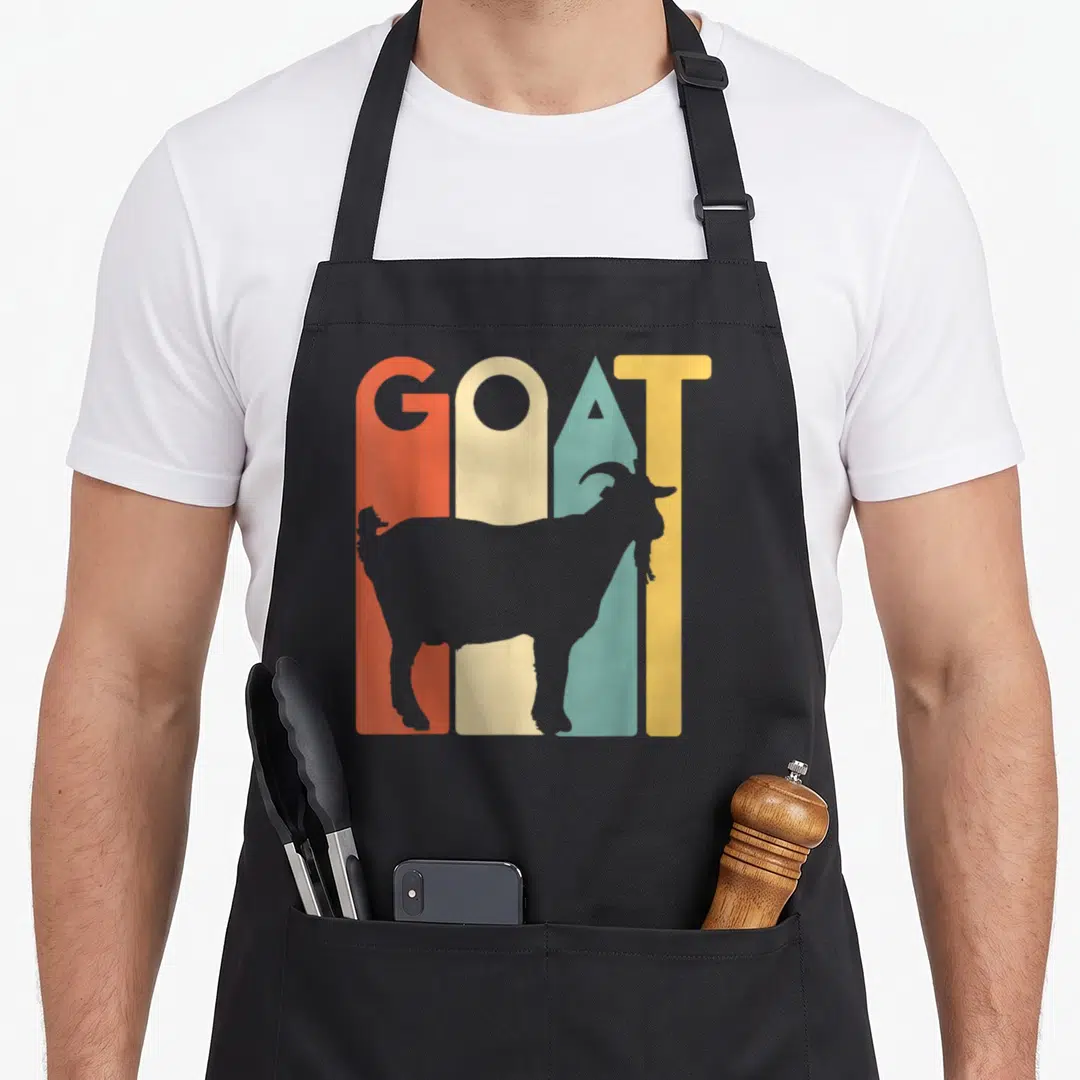 Animal goat apron - GOAT text over orange yellow teal grey stripes with grey goat silhouette — shown on a black cotton canvas apron against a white background