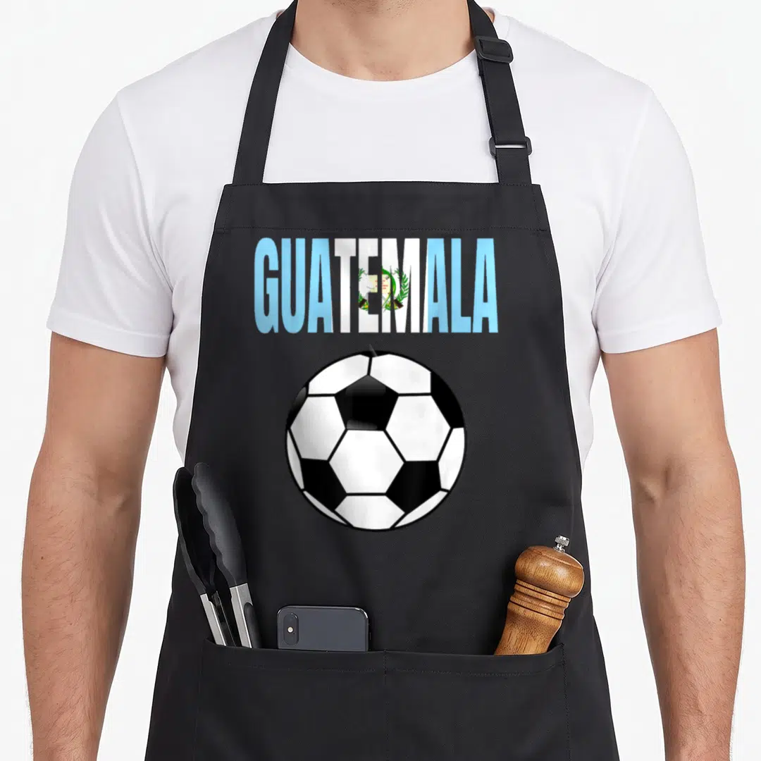 Soccer guatemalan aprons - GUATEMALA text filled with flag pattern above a black and white soccer ball — shown on a black cotton canvas apron against a white background