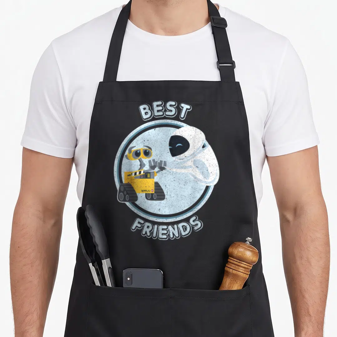 Wall friends apron - WALL-E and EVE high-fiving inside blue circle with best friends text — shown on a black cotton canvas apron against a white background
