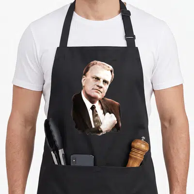 Graham billy apron - Portrait of a man in a suit and tie in black white and beige — shown on a black cotton canvas apron against a white background
