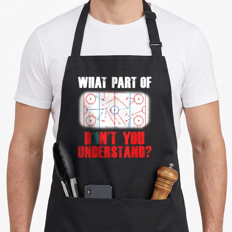 Player frappe apron - Hockey play diagram with puck and text WHAT PART OF DON'T YOU UNDERSTAND in red and white — shown on a black cotton canvas apron against a white background