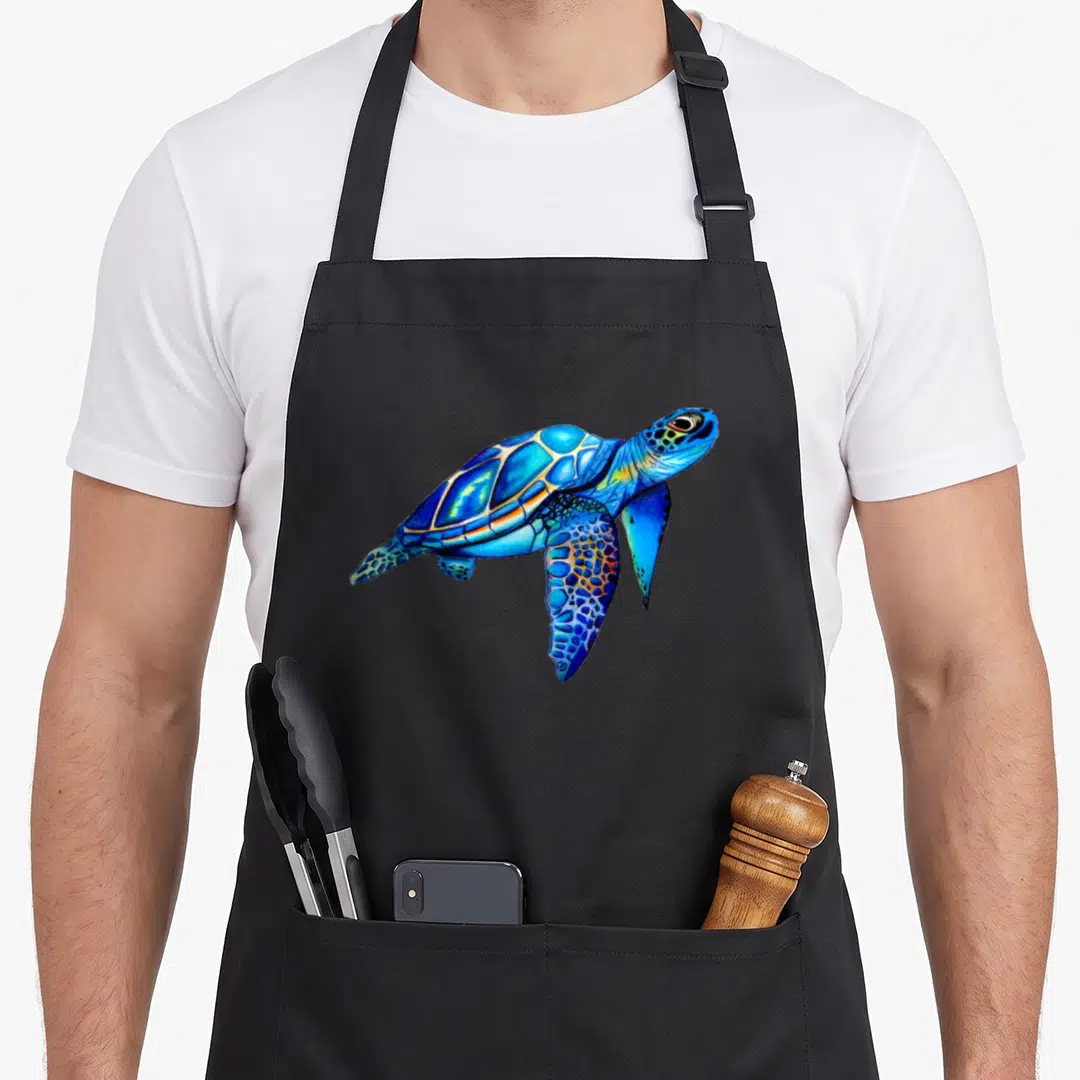 Watercolor hawaiian apron - Blue cyan yellow watercolor sea turtle illustration — shown on a black cotton canvas apron against a white background