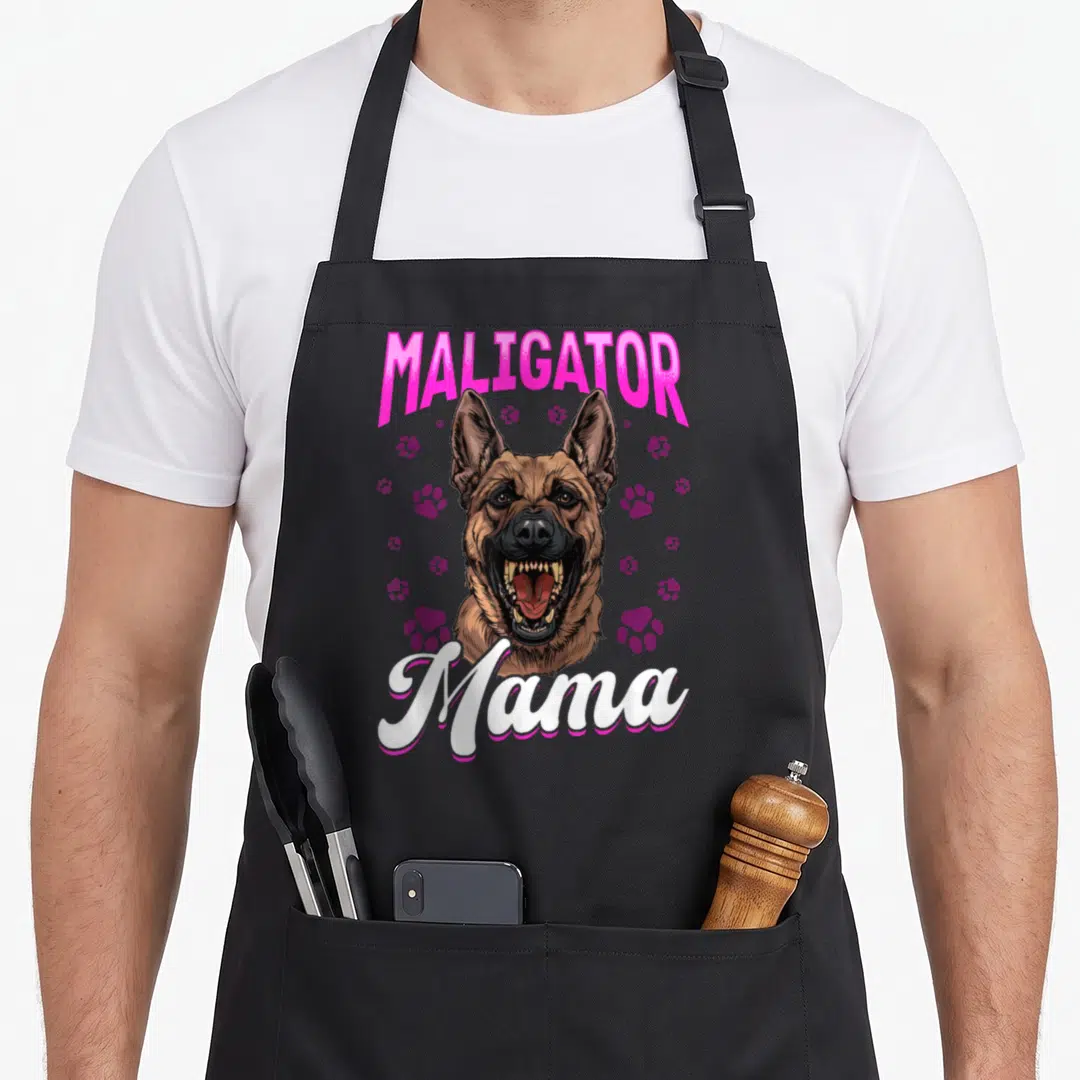 Maligator dog breed aprons - Cartoon Belgian Malinois with pink MALIGATOR text and purple paw prints — shown on a black cotton canvas apron against a white background