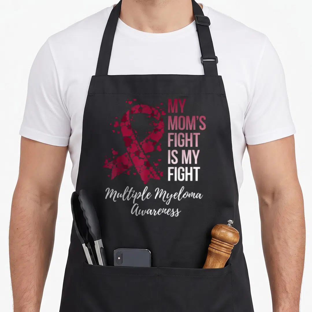 Fight myeloma awareness apron - Ribbon made of hearts with text MY MOM'S FIGHT IS MY FIGHT in red pink white — shown on a black cotton canvas apron against a white background