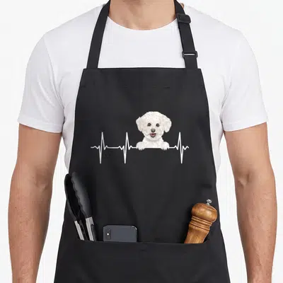 Bichon dog apron - Realistic white dog head and paws above a horizontal white heartbeat line — shown on a black cotton canvas apron against a white background