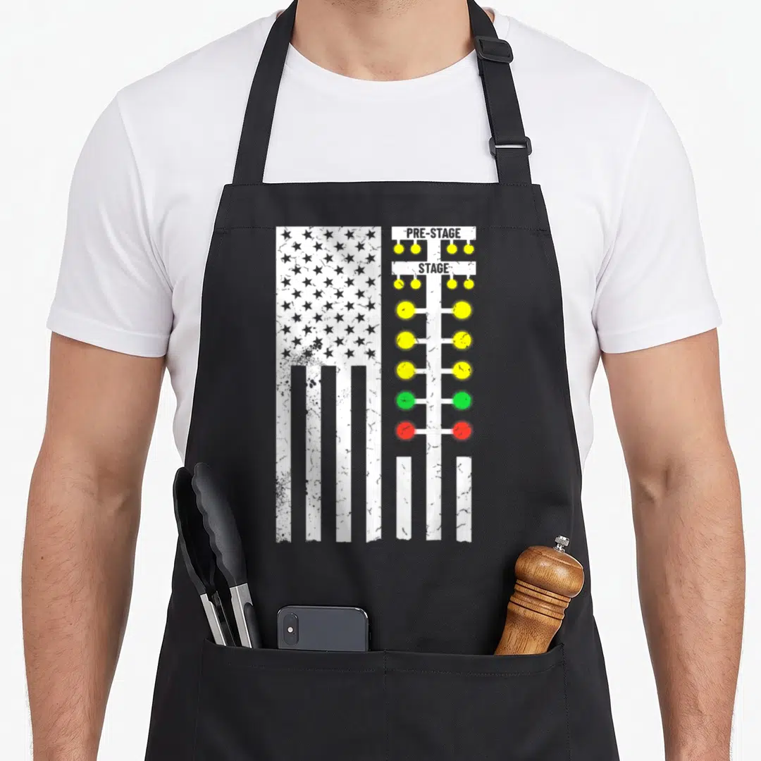 Drag track apron - Distressed USA flag next to vertical light tree with yellow, green, and red bulbs labeled PRE-STAGE — shown on a black cotton canvas apron against a white background