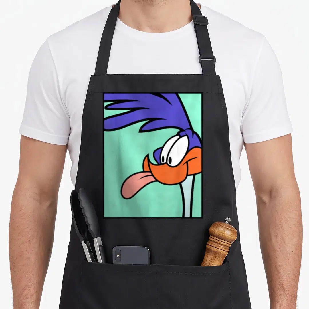 Vintage runner road apron - Cartoon bird head with blue feathers, orange beak, pink tongue on mint background — shown on a black cotton canvas apron against a white background