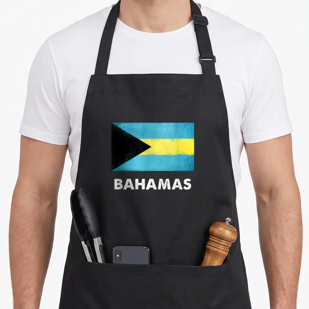 Bahamas flag bahamian apron - Distressed Bahamas flag rectangle above white BAHAMAS text in blue yellow black white — shown on a black cotton canvas apron against a white background