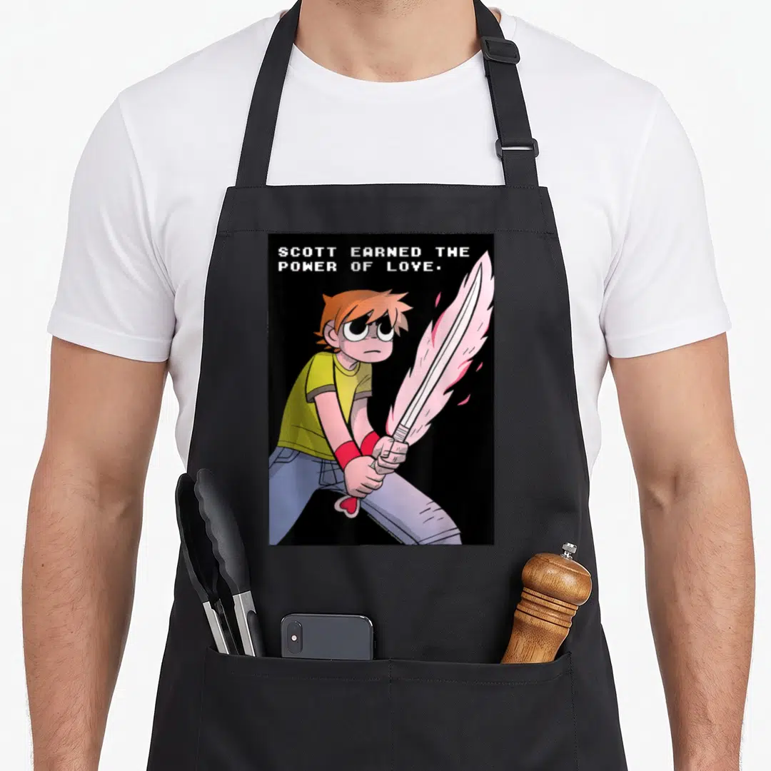 Earned pilgrim apron - Cartoon man holding pink energy sword below stacked white text SCOTT EARNED THE POWER OF LOVE — shown on a black cotton canvas apron against a white background