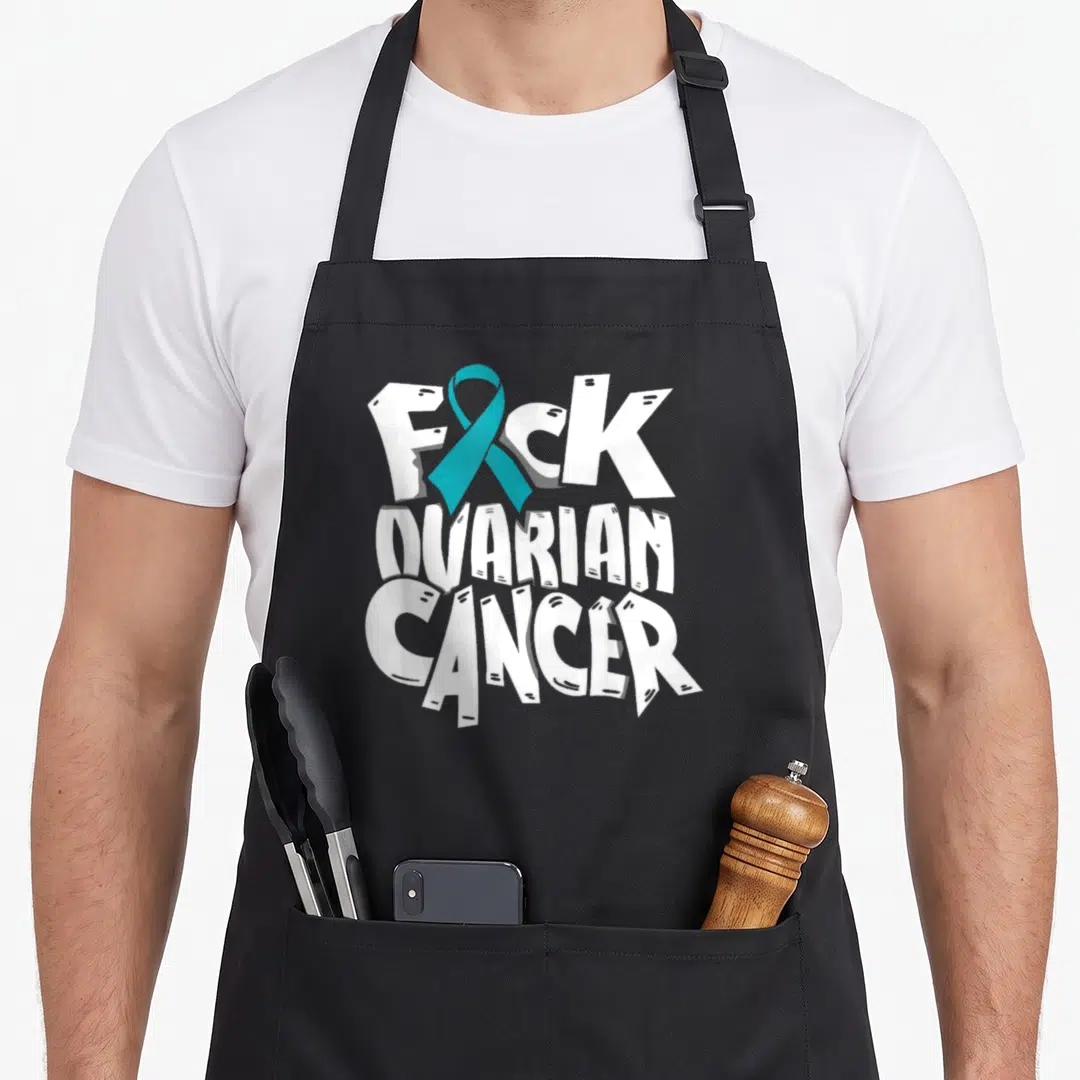 Ovarian cancer awareness ribbon apron - White stacked text FUCK OVARIAN CANCER with teal ribbon replacing the U — shown on a black cotton canvas apron against a white background