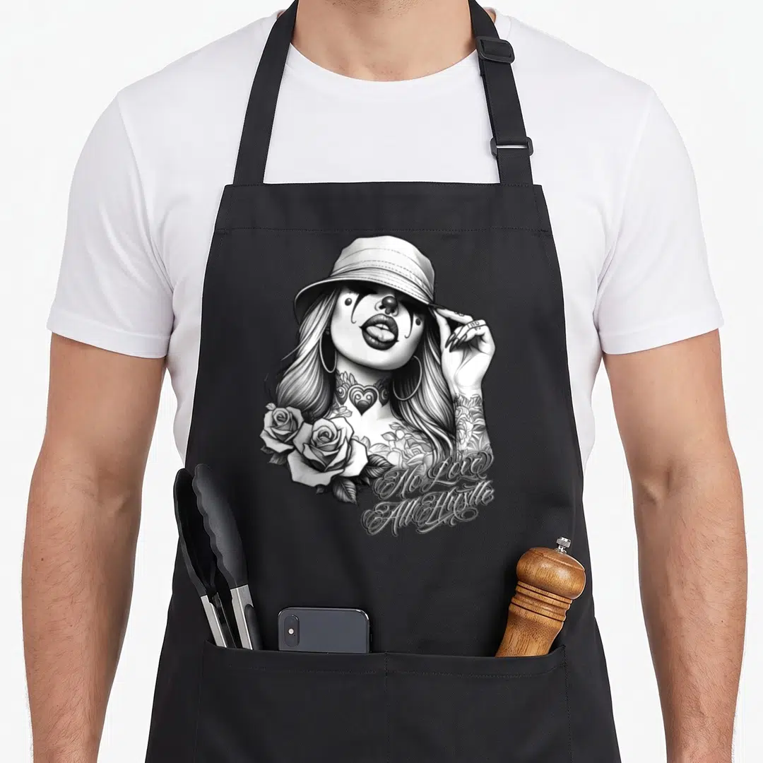 Hustle tattoo apron - Chicana clown woman with roses and No Love All Hustle text in black and white line art — shown on a black cotton canvas apron against a white background