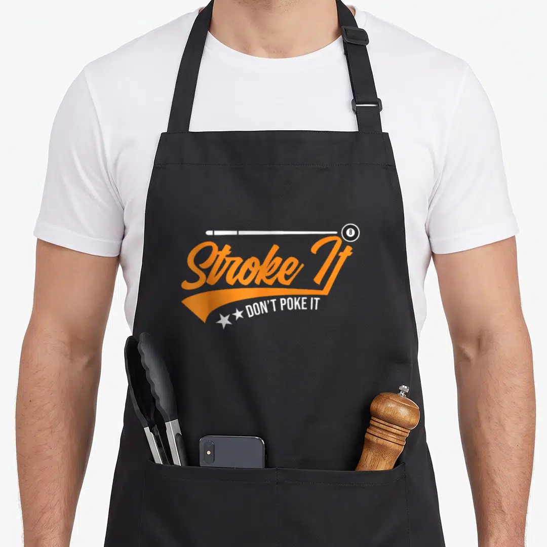 Stroke throw player apron - White pool cue, 8-ball, orange script Stroke It, white Don Poke It text, two stars — shown on a black cotton canvas apron against a white background