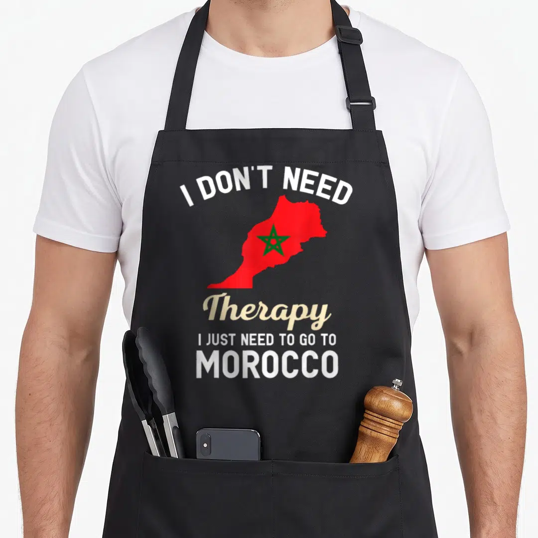 Morocco travel aprons - Red map of Morocco with green star and white text saying I just need to go to Morocco — shown on a black cotton canvas apron against a white background