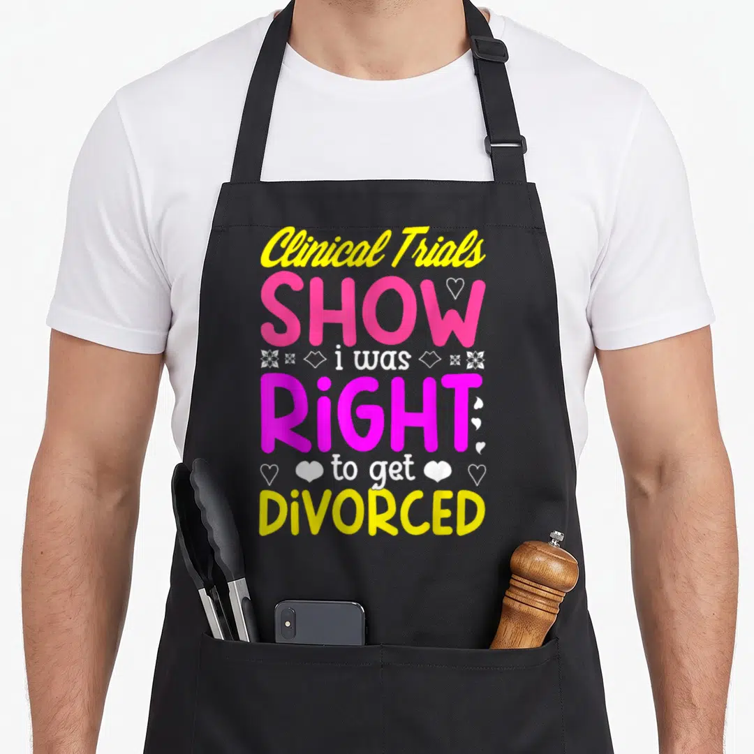 Divorce congrats apron - Stacked yellow pink and white text reading Clinical Trials show i was right to get divorced — shown on a black cotton canvas apron against a white background