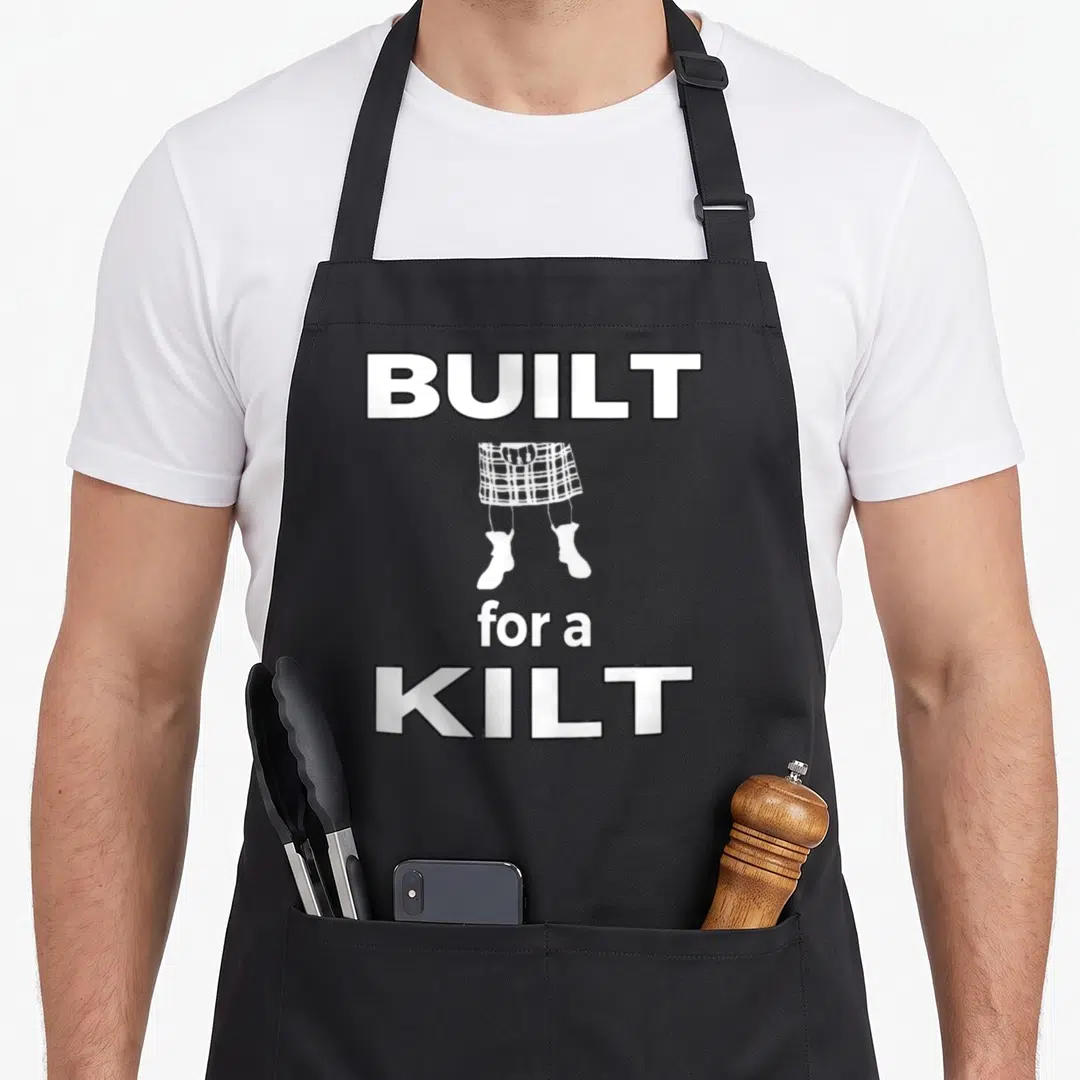 Built kilt apron - White BUILT for a KILT text and kilt legs illustration on black background — shown on a black cotton canvas apron against a white background