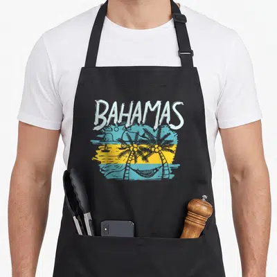 Proud bahamas flag nassau bahamian apron - Retro BAHAMAS beach scene with blue yellow stripes, palm trees, hammock — shown on a black cotton canvas apron against a white background