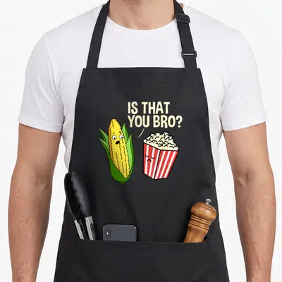 Bro hiking lover apron - Cartoon corn asks is that you bro to a red and white striped popcorn box — shown on a black cotton canvas apron against a white background