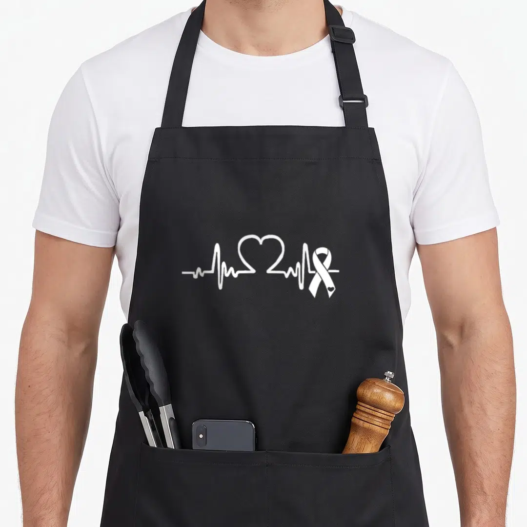 Atrial heart disease awareness apron - White EKG heartbeat line with heart shape and awareness ribbon on grey background — shown on a black cotton canvas apron against a white background