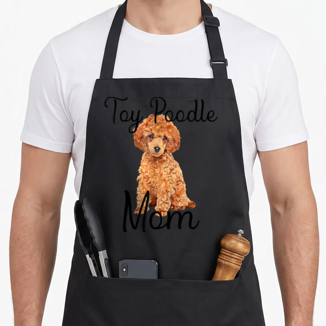 Waffle dog apron - Arched Toy Poodle text above an apricot poodle photo with Mom text below — shown on a black cotton canvas apron against a white background