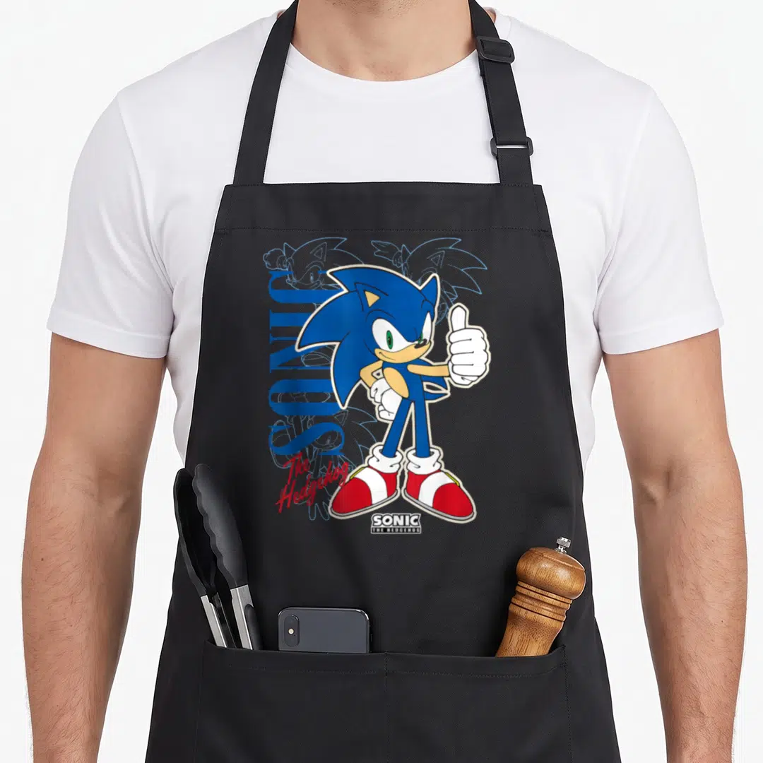 Thumb crazy hedgehog lady apron - Sonic giving thumbs up with vertical blue SONIC text and red script on black — shown on a black cotton canvas apron against a white background