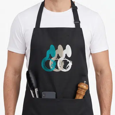 Music tuba apron - Three overlapping french horns in teal beige white minimalist silhouettes — shown on a black cotton canvas apron against a white background