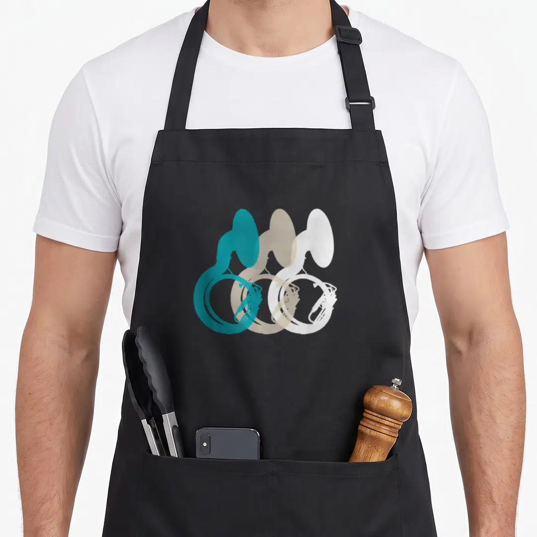 Music tuba apron - Three overlapping french horns in teal beige white minimalist silhouettes — shown on a black cotton canvas apron against a white background